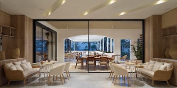 a room with a large glass wall and a table and chairs