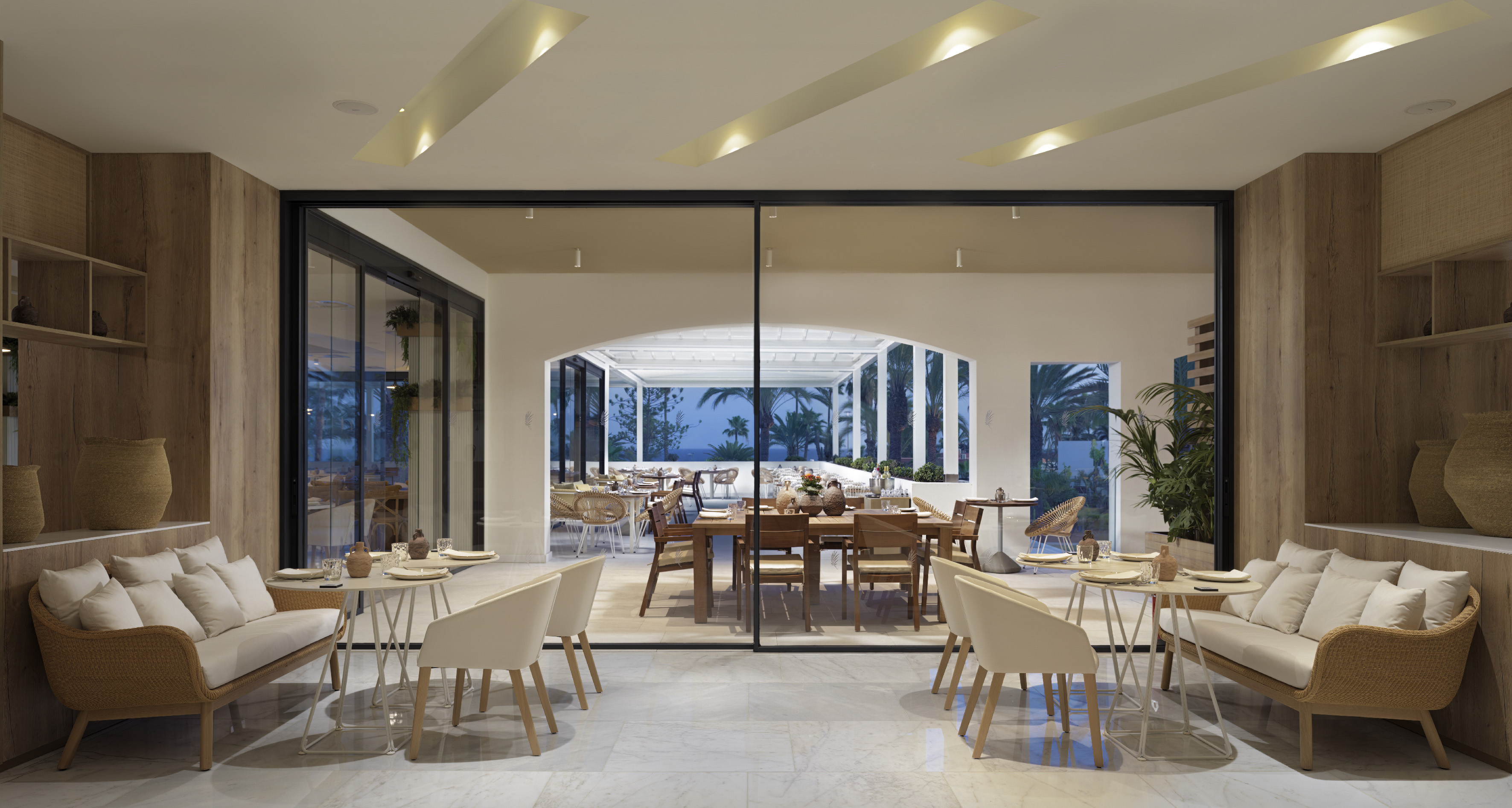 a room with a large glass wall and a table and chairs
