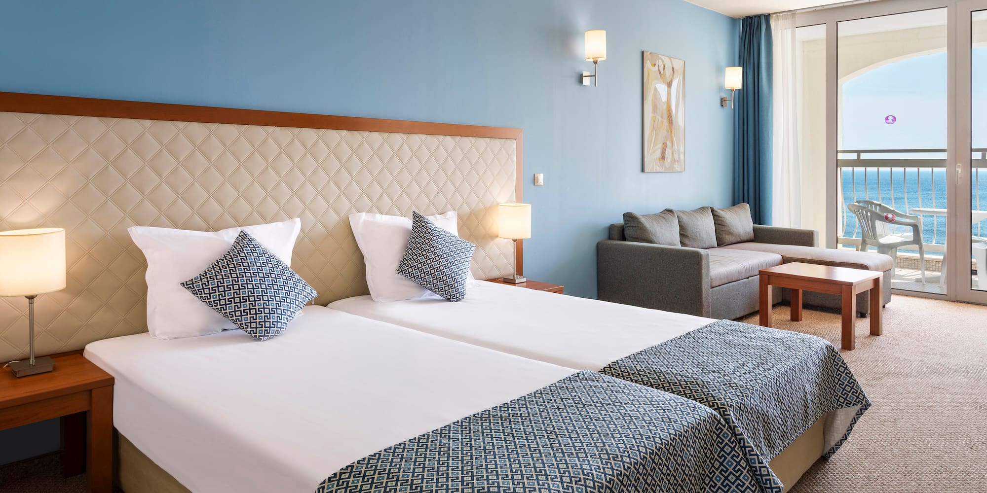 a room with two beds and a couch