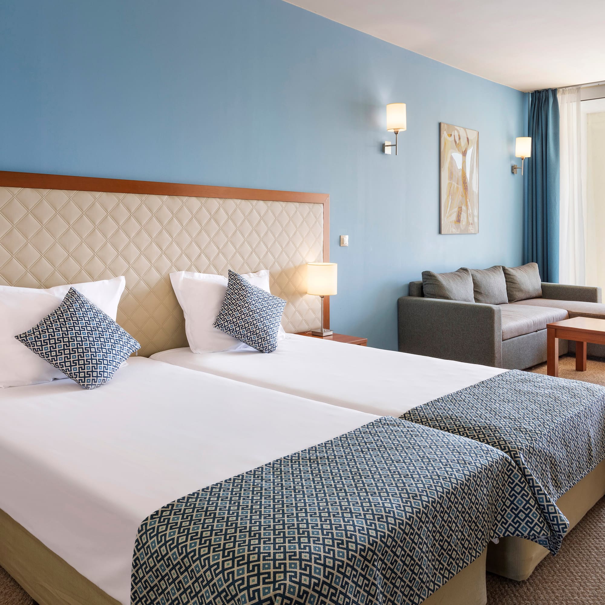 a room with two beds and a couch