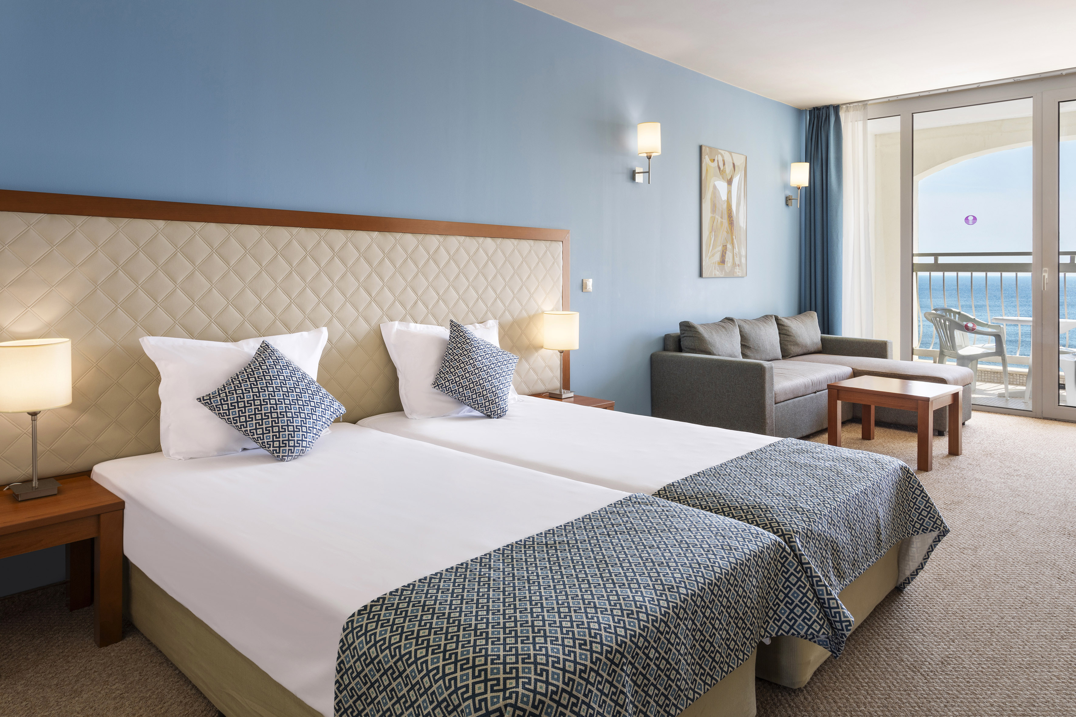 a room with two beds and a couch