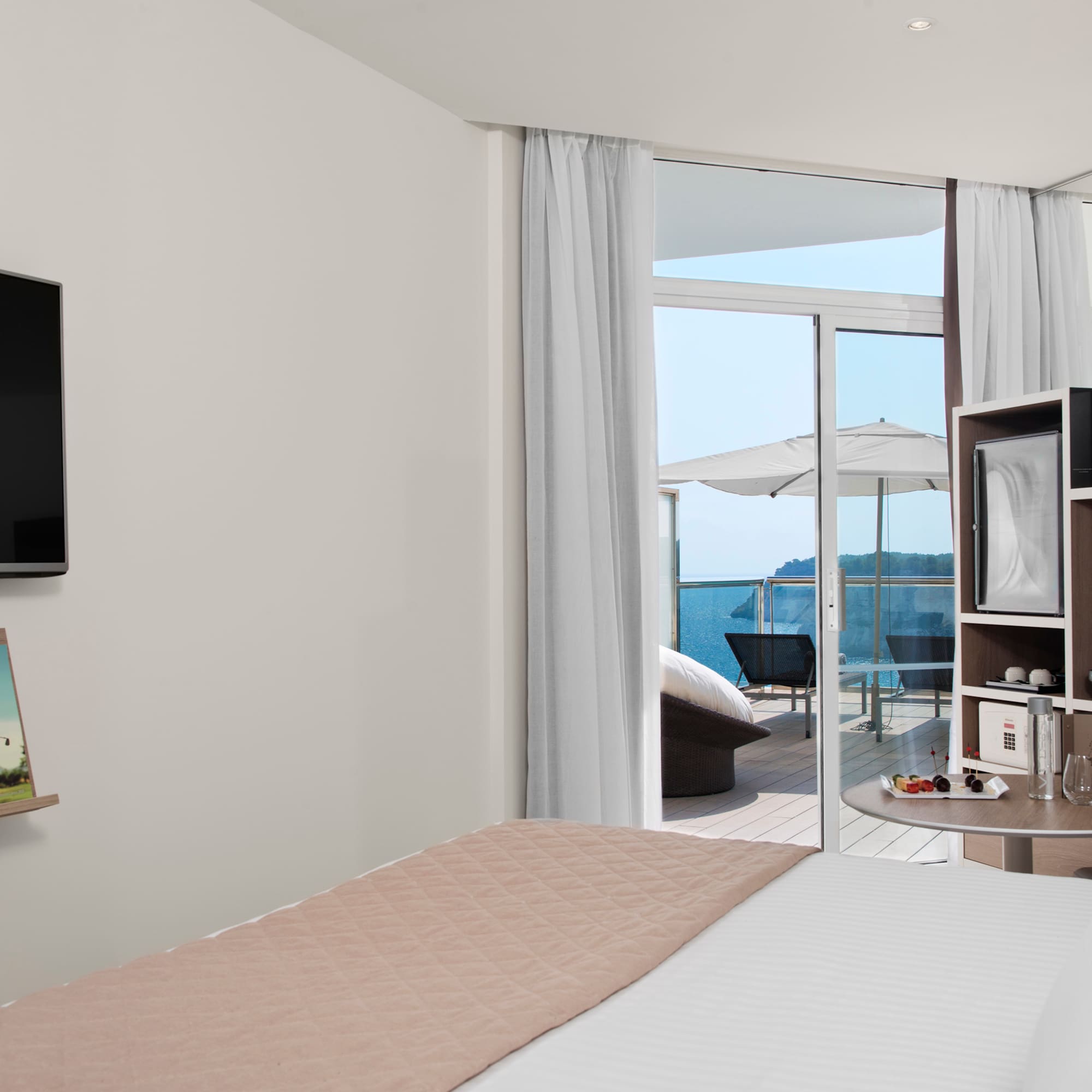 a room with a bed and a television