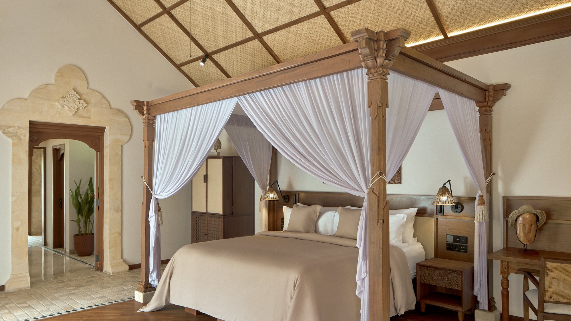 a bed with white curtains in a room