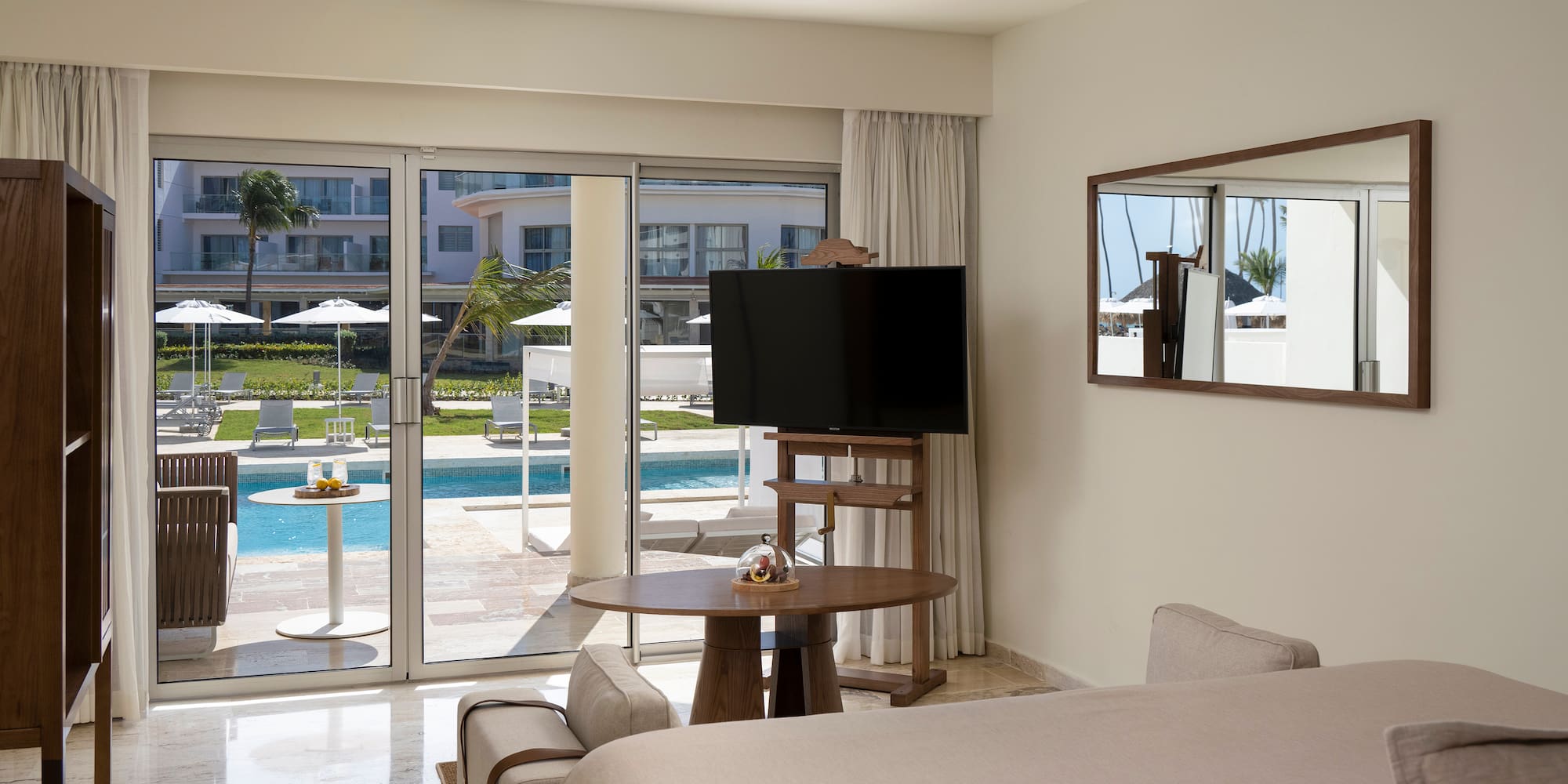 a room with a television and a pool