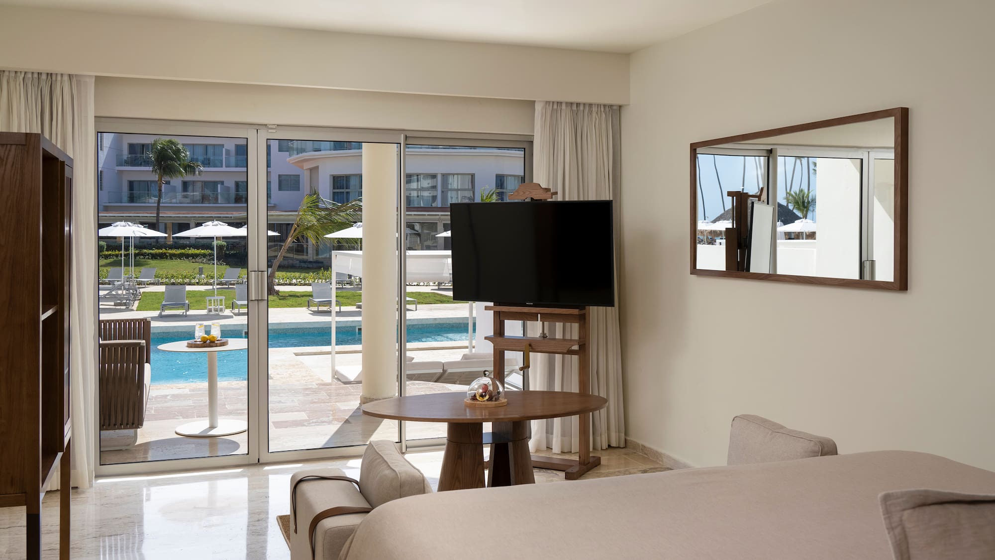 a room with a television and a pool