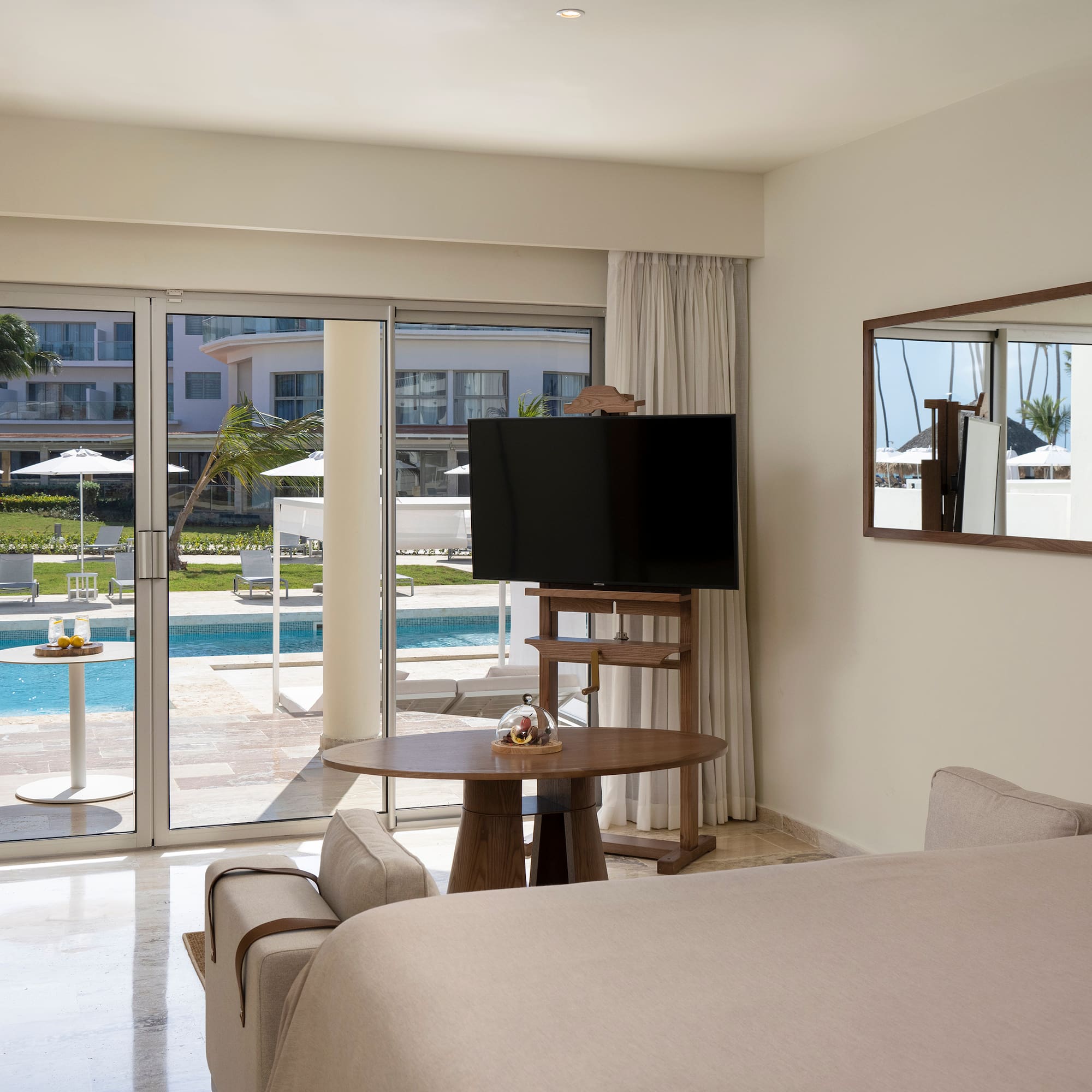 a room with a television and a pool