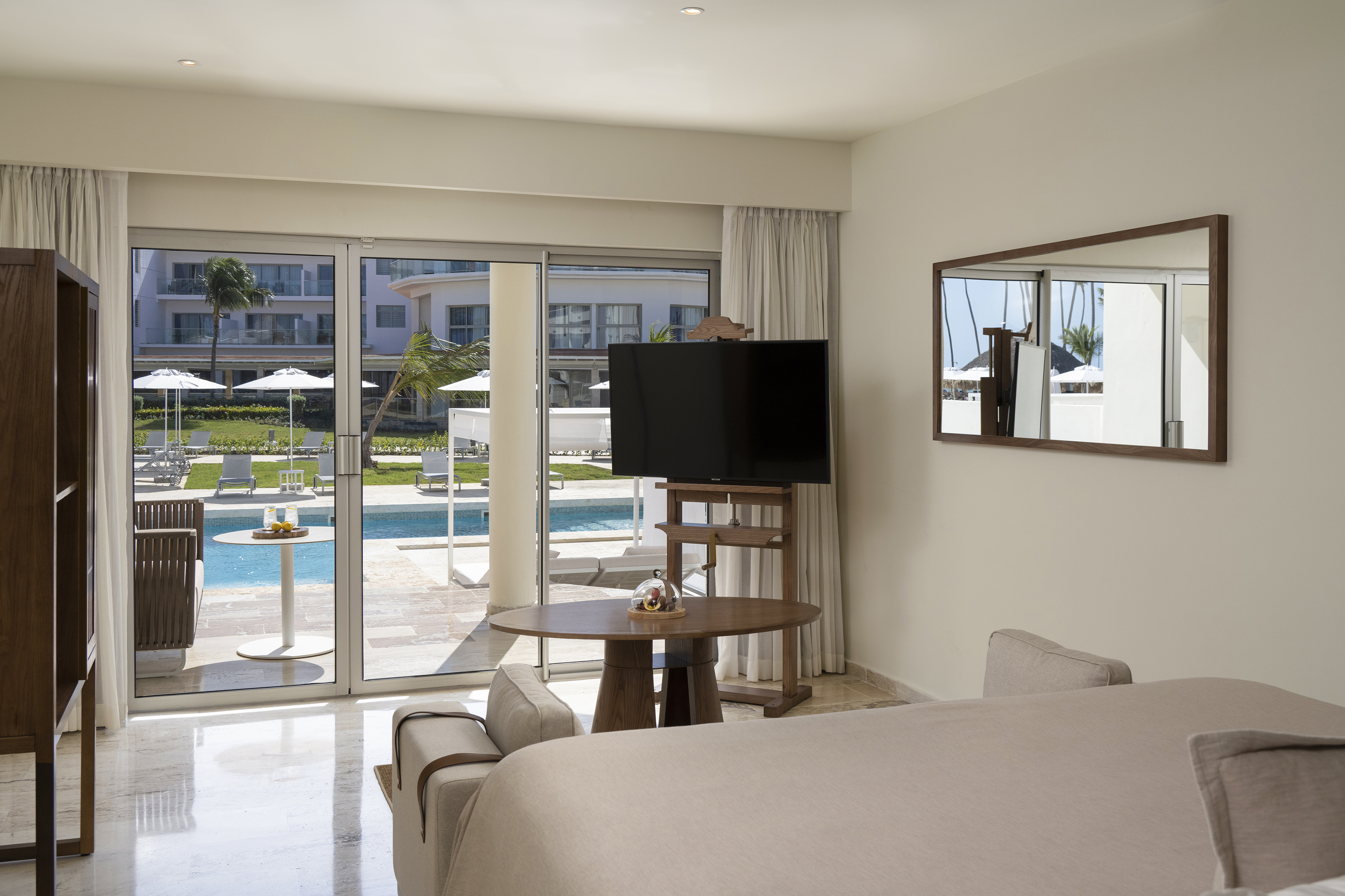 a room with a television and a pool