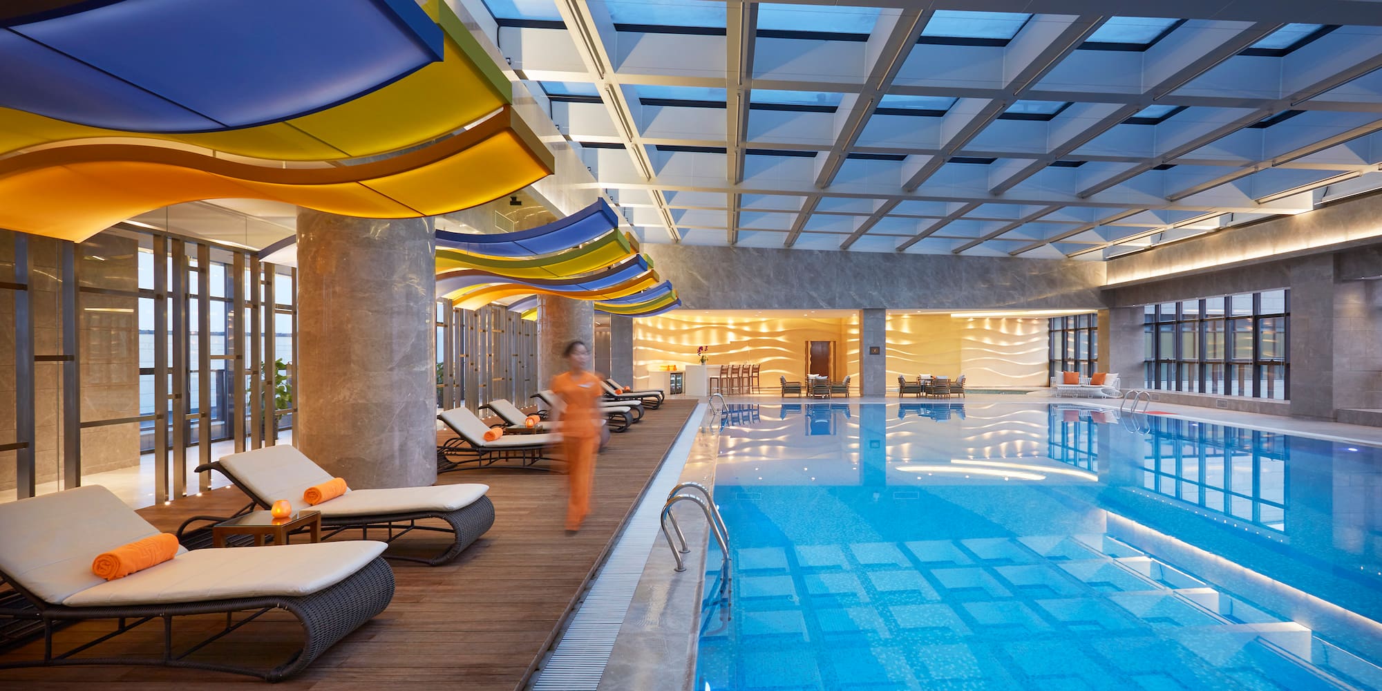 a person walking next to a swimming pool