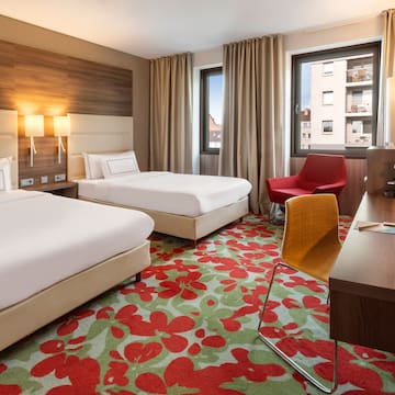 a room with two beds and a desk