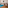 Modern living room with beige sofa, blue rug, coffee table, and dining area.