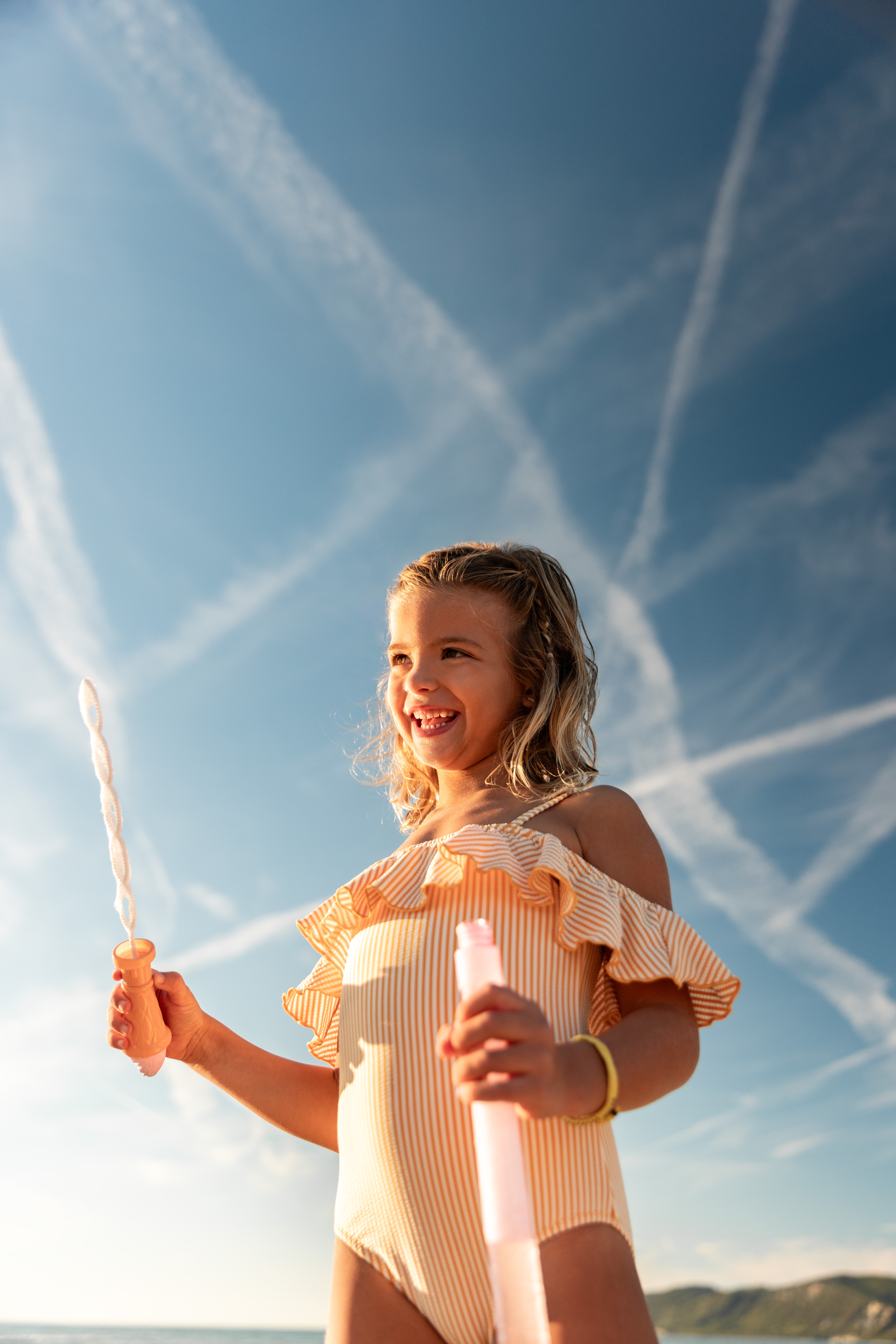 a girl holding bubbles and a tube