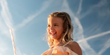 a girl holding bubbles and a tube