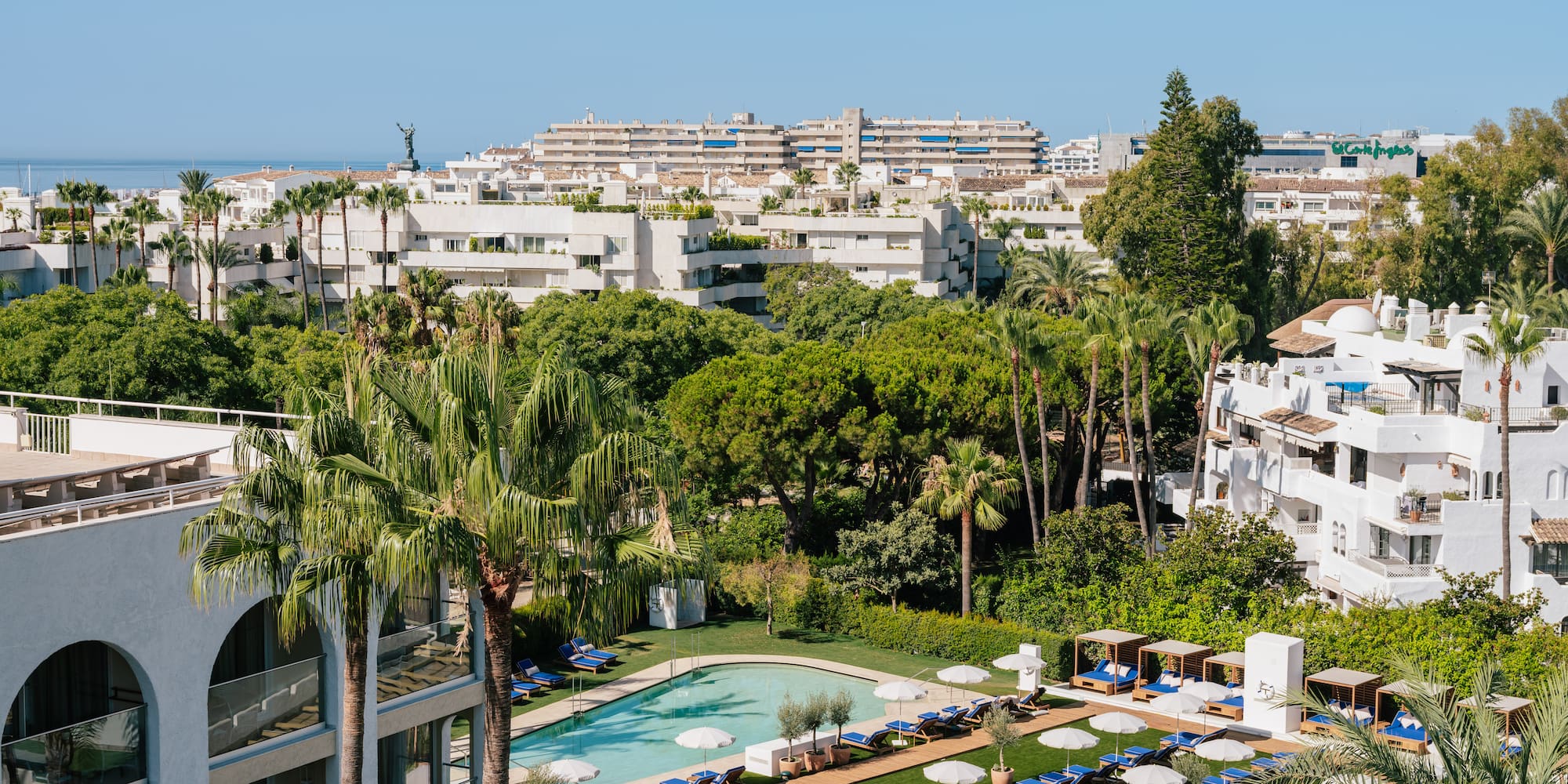 a pool and chairs in a resort