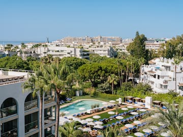 a pool and chairs in a resort