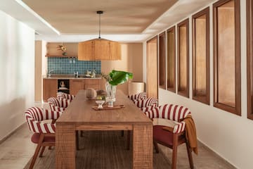 a dining room with a table and chairs