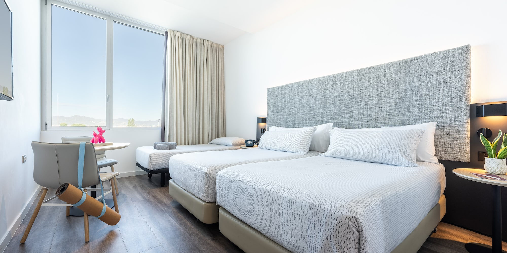 a room with two beds and a table
