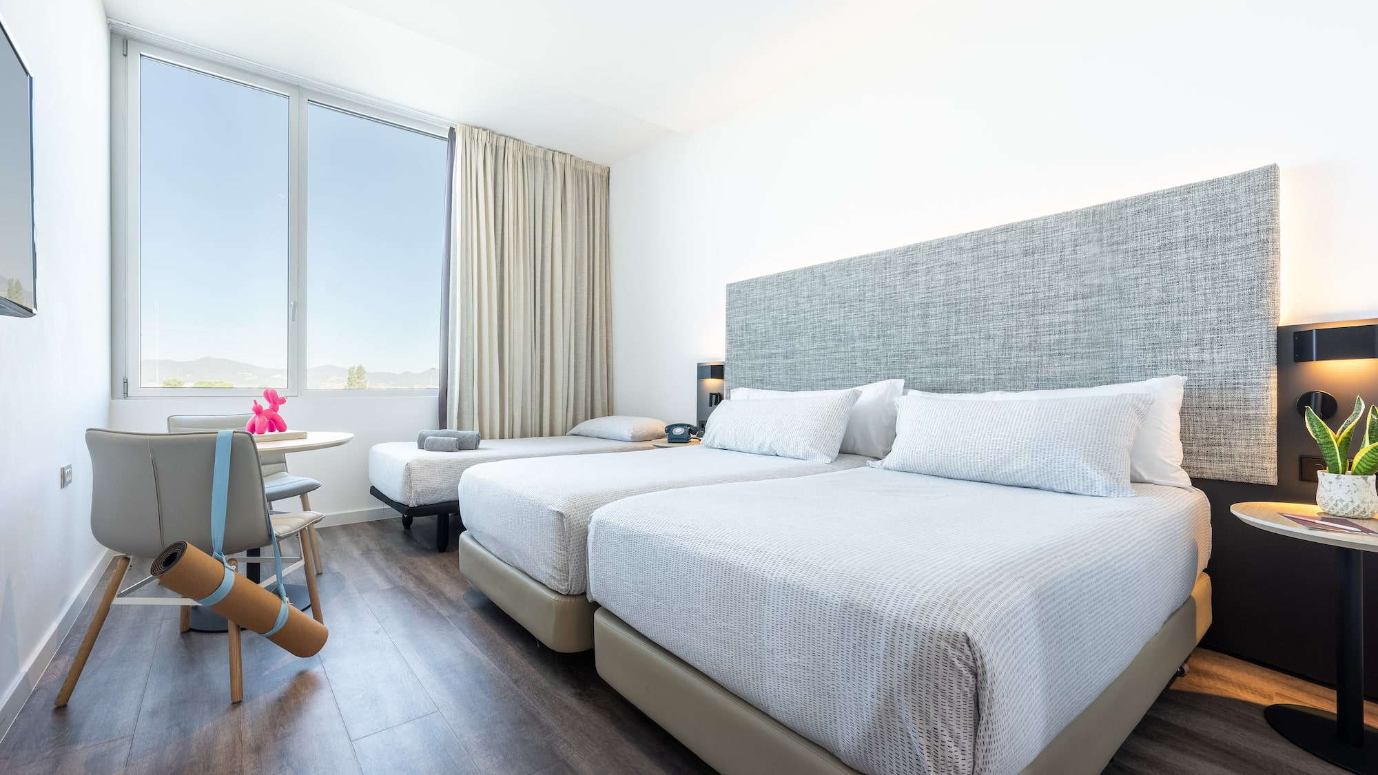 a room with two beds and a table