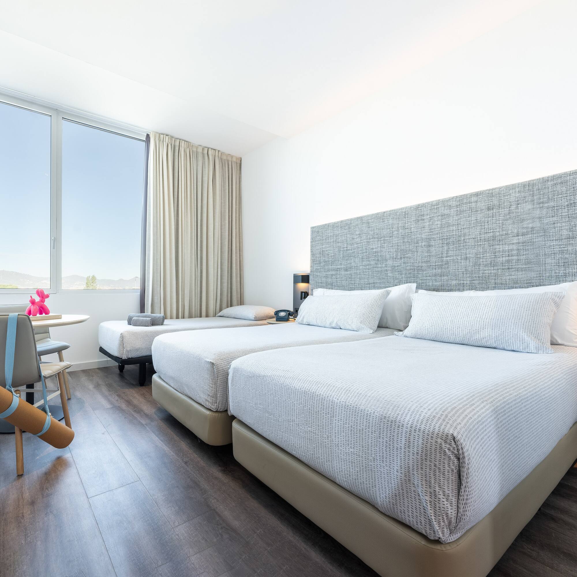 a room with two beds and a table