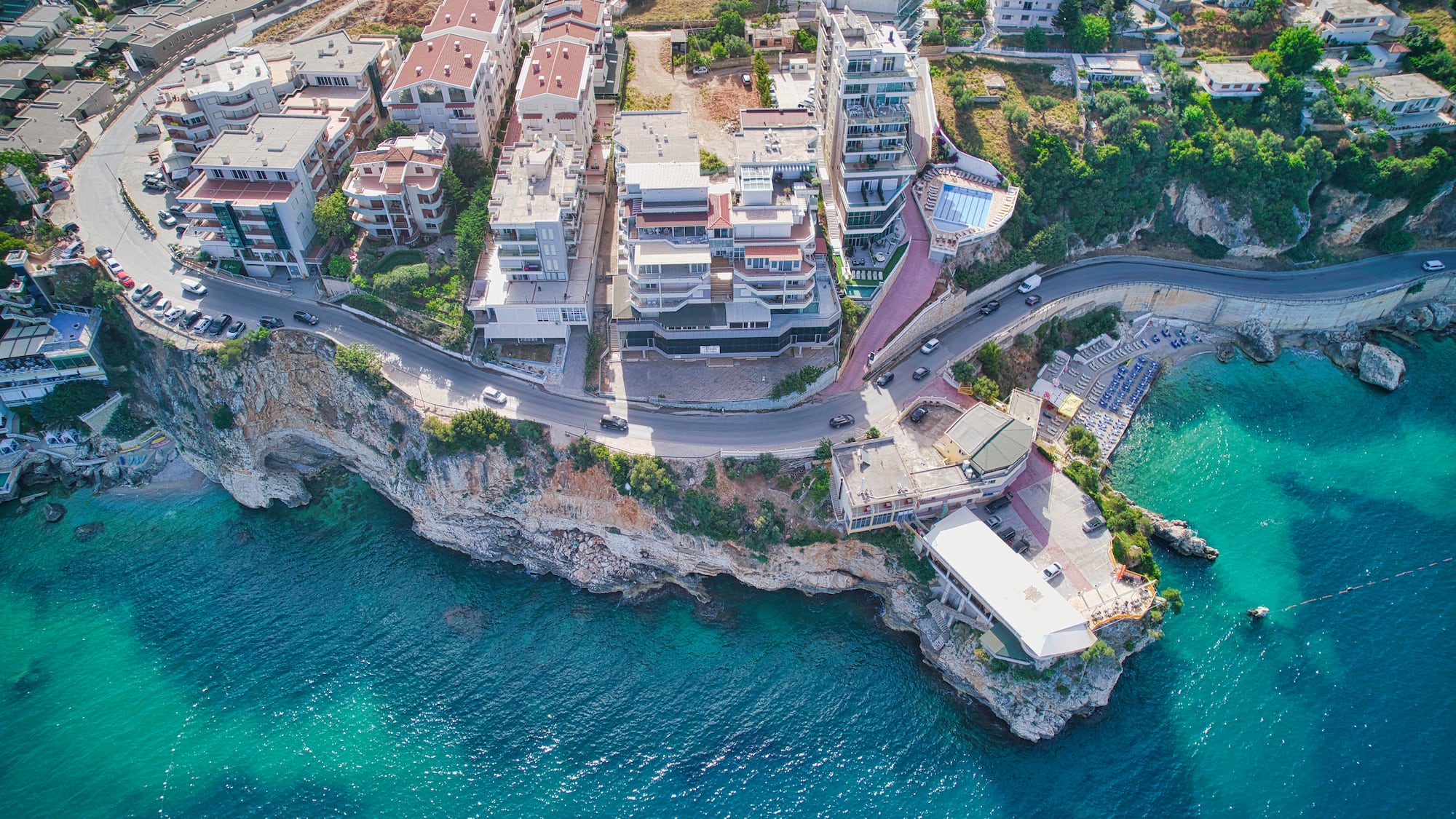 a aerial view of a town on a cliff by the water