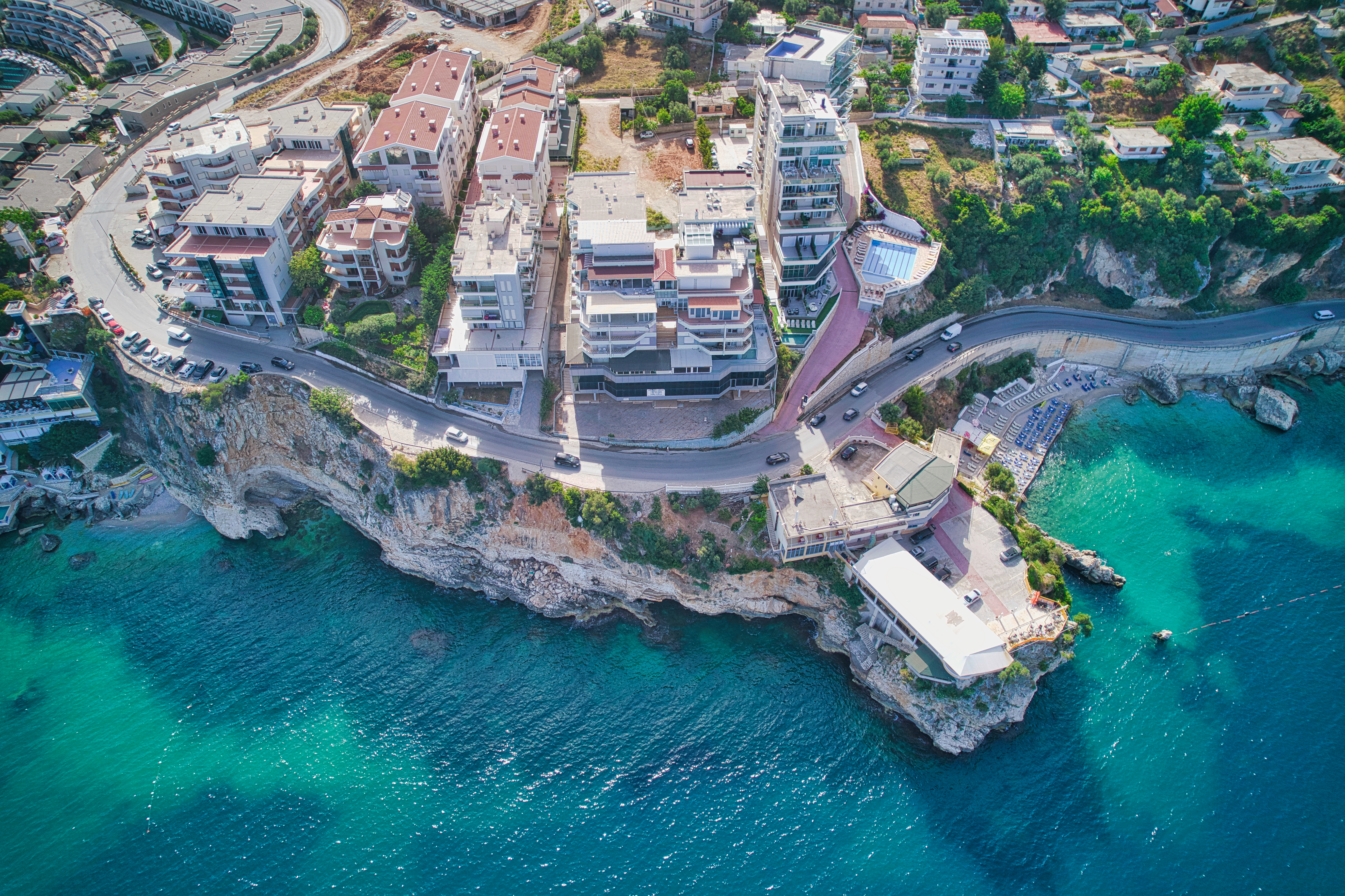 a aerial view of a town on a cliff by the water
