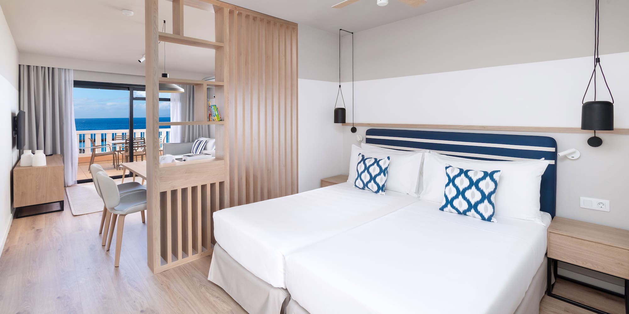 a room with two beds and a wood floor