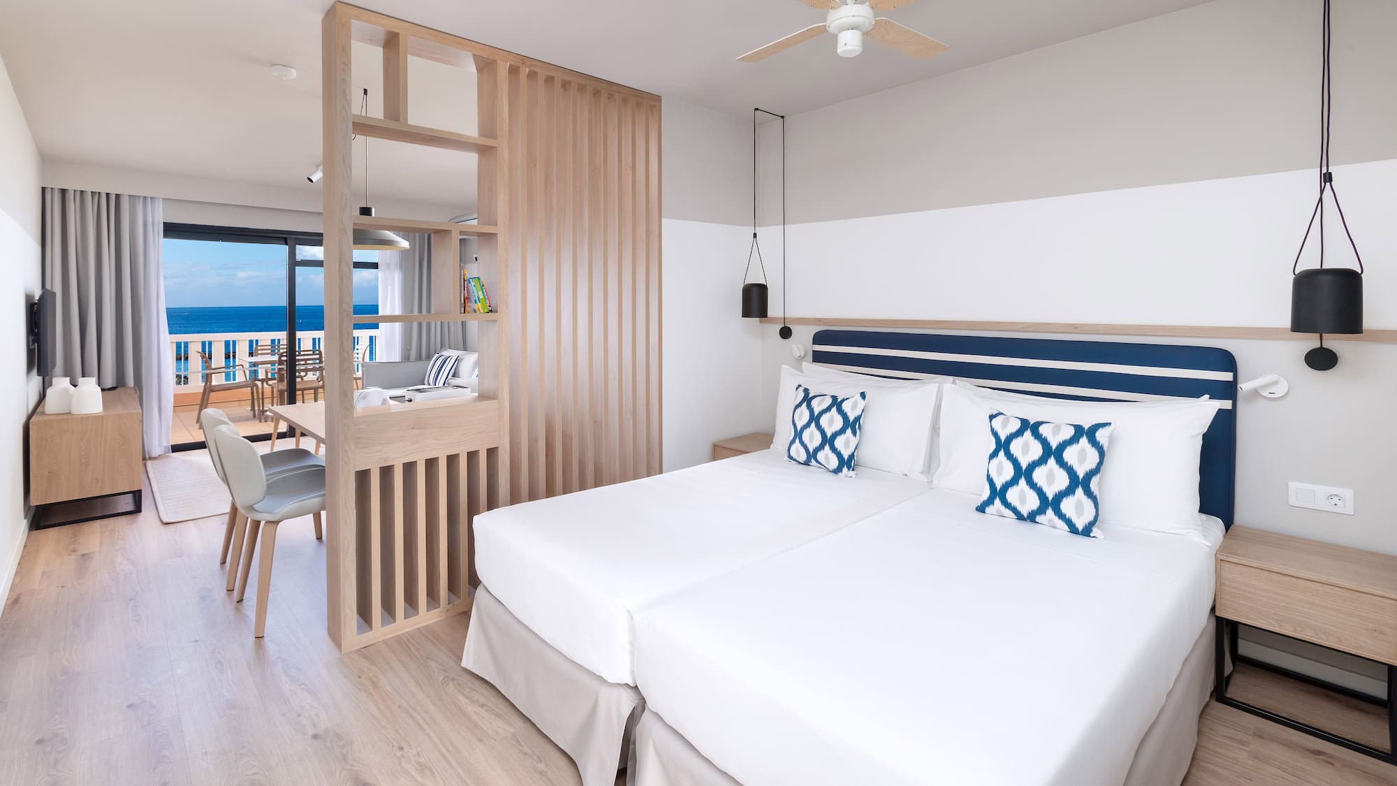 a room with two beds and a wood floor