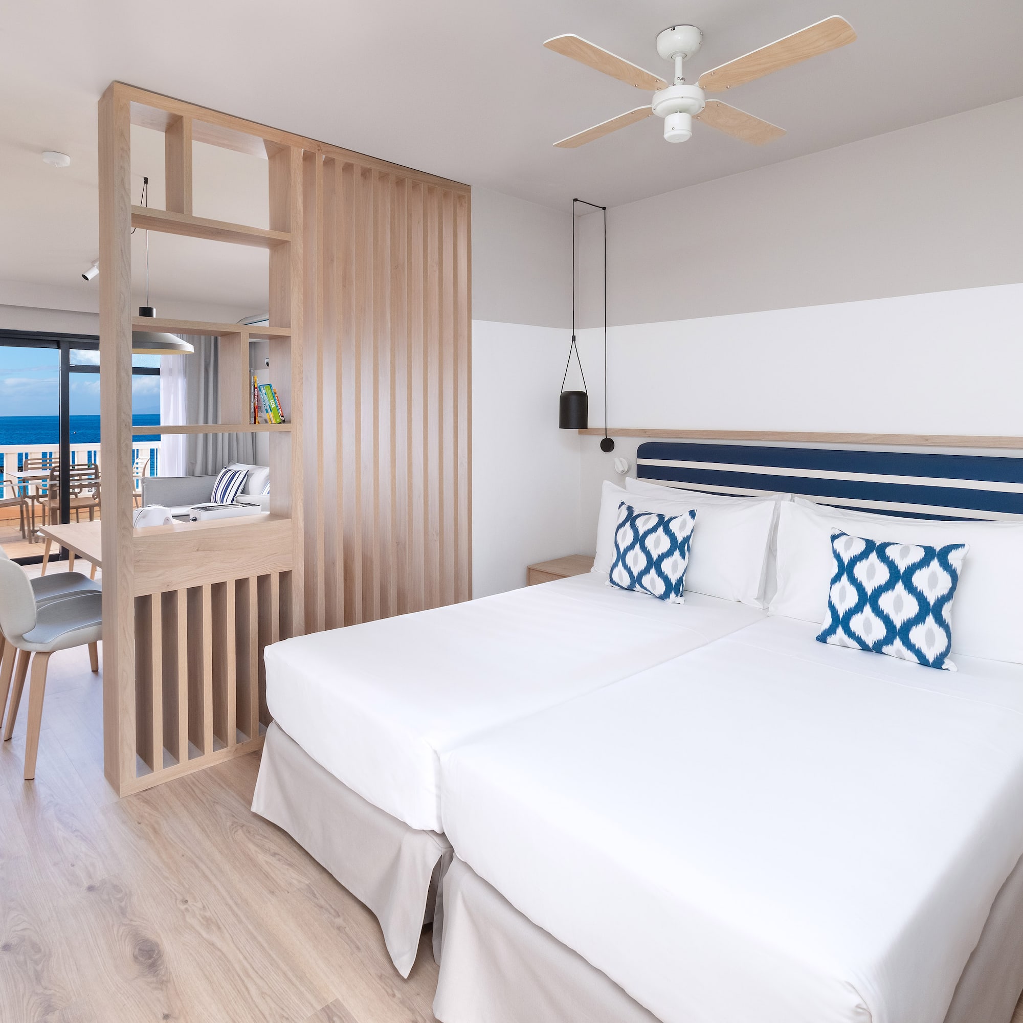 a room with two beds and a wood floor