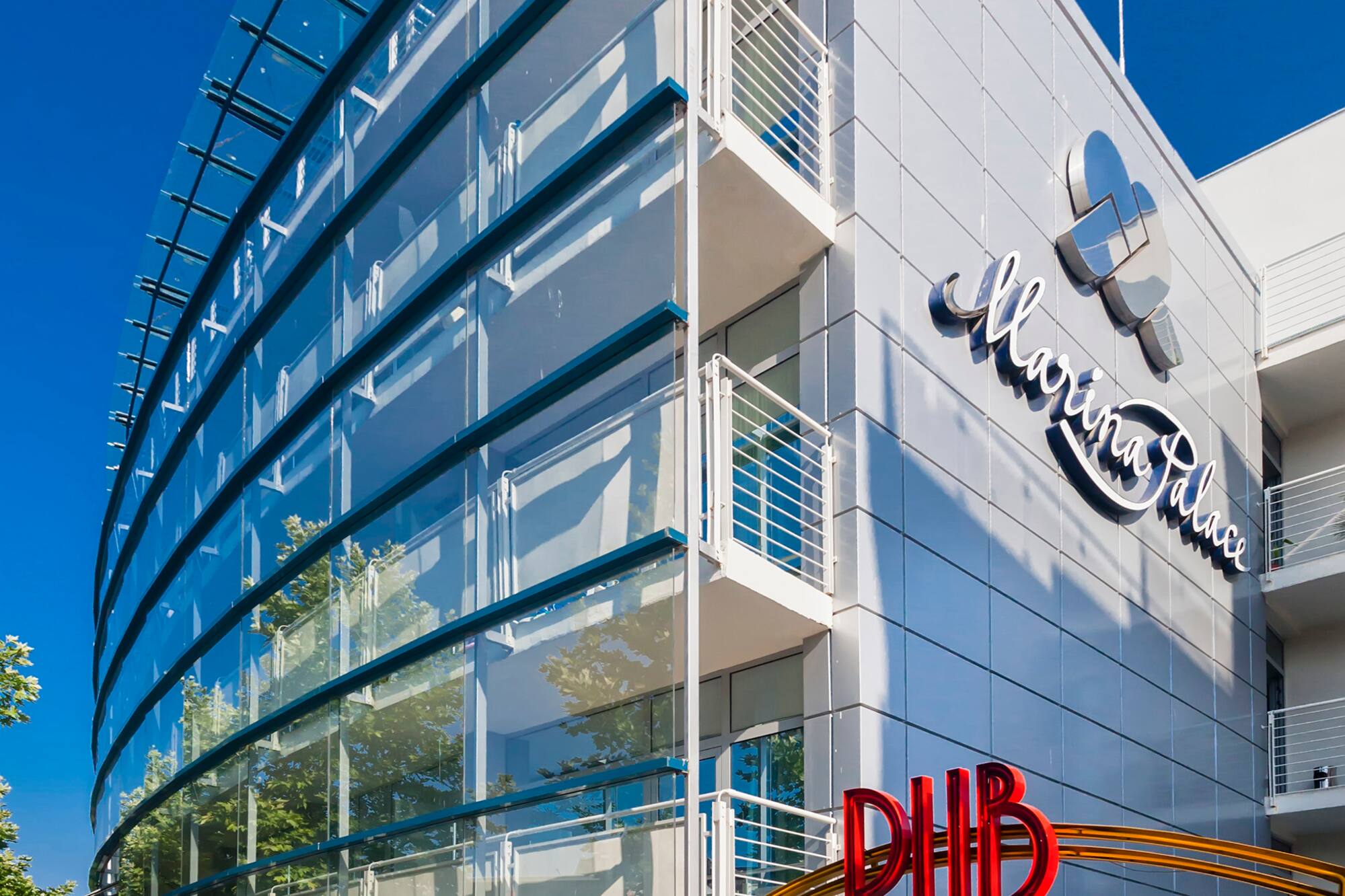 a building with glass walls and a sign