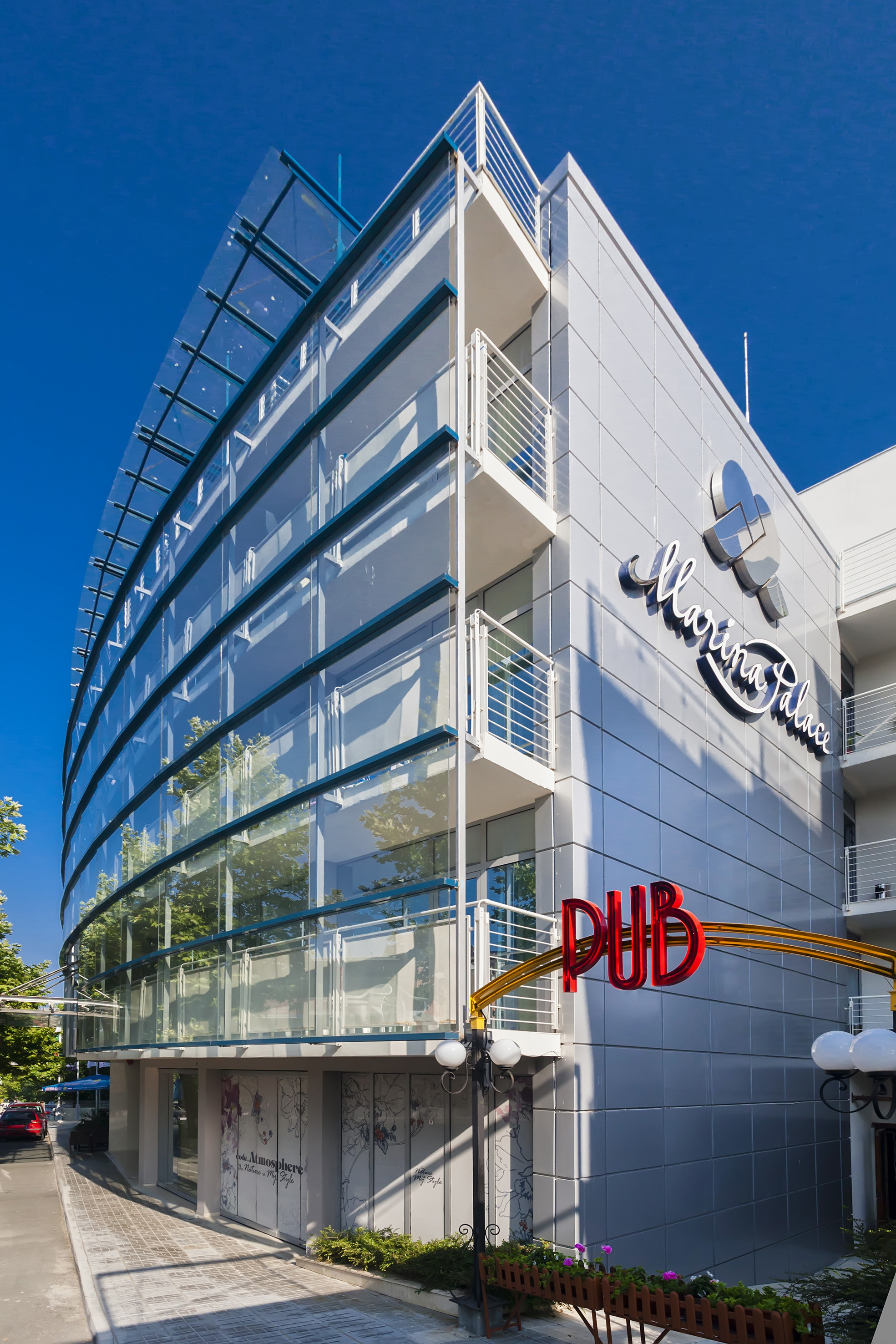 a building with glass walls and a sign