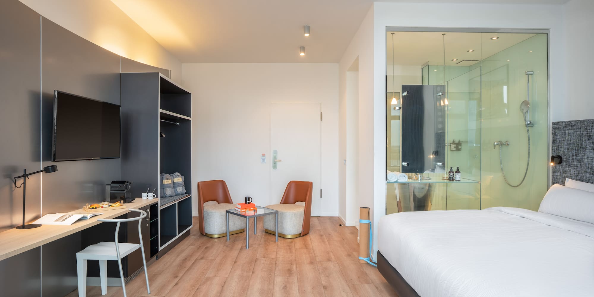 a room with a bed and a table and chairs