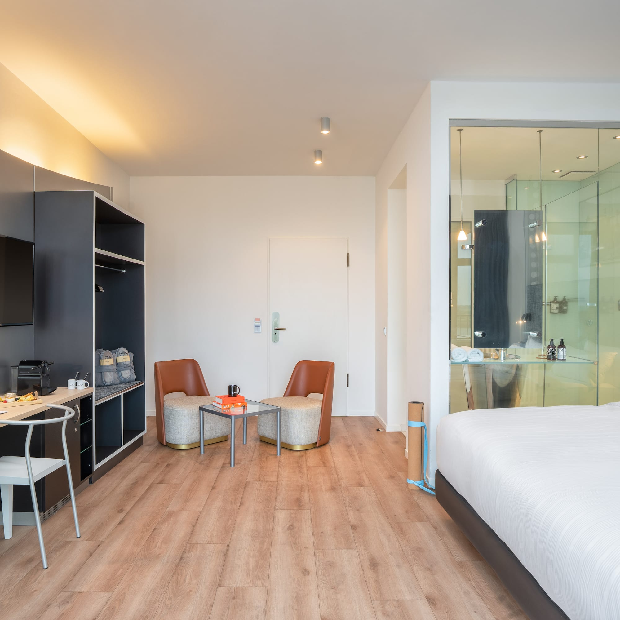 a room with a bed and a table and chairs