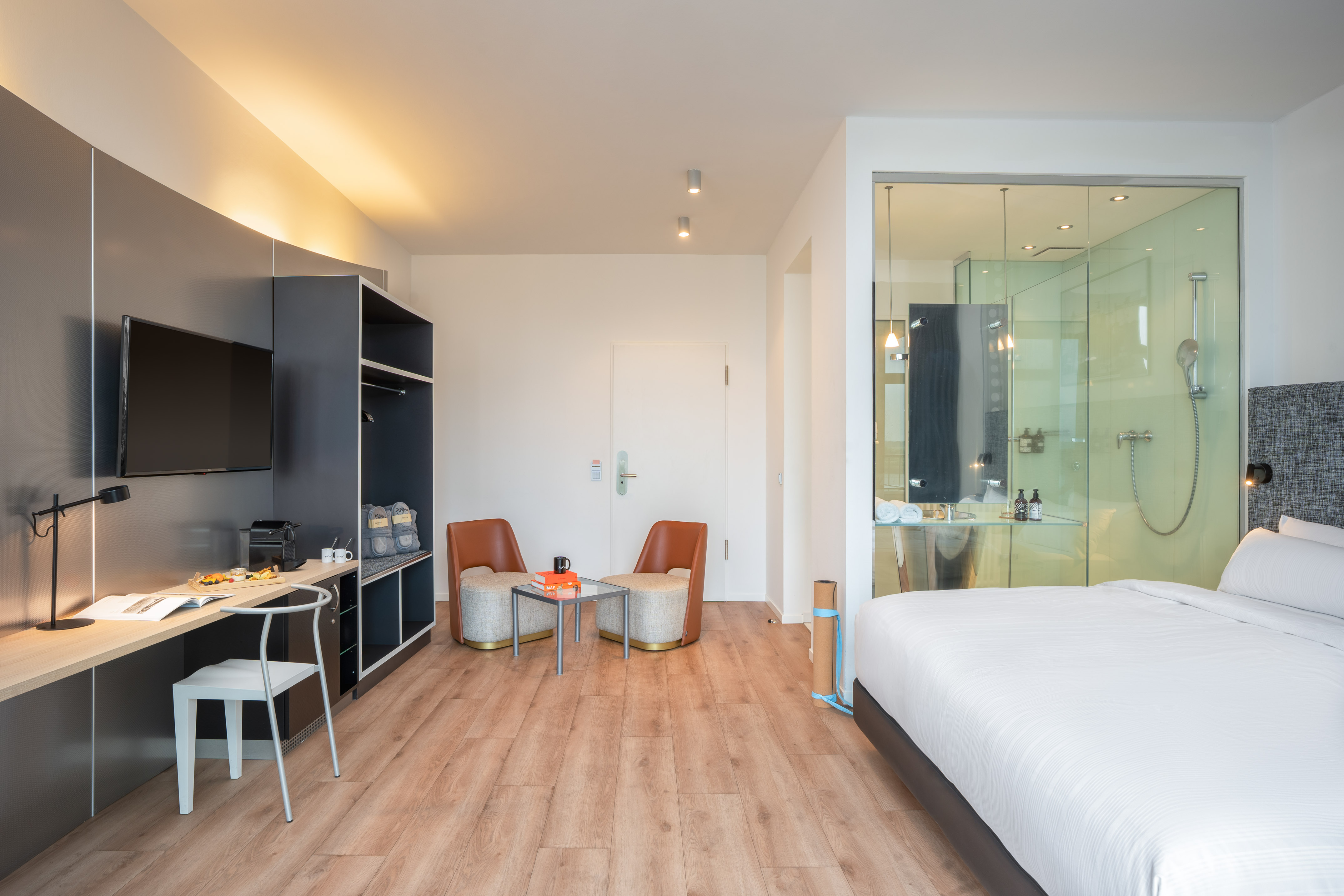 a room with a bed and a table and chairs