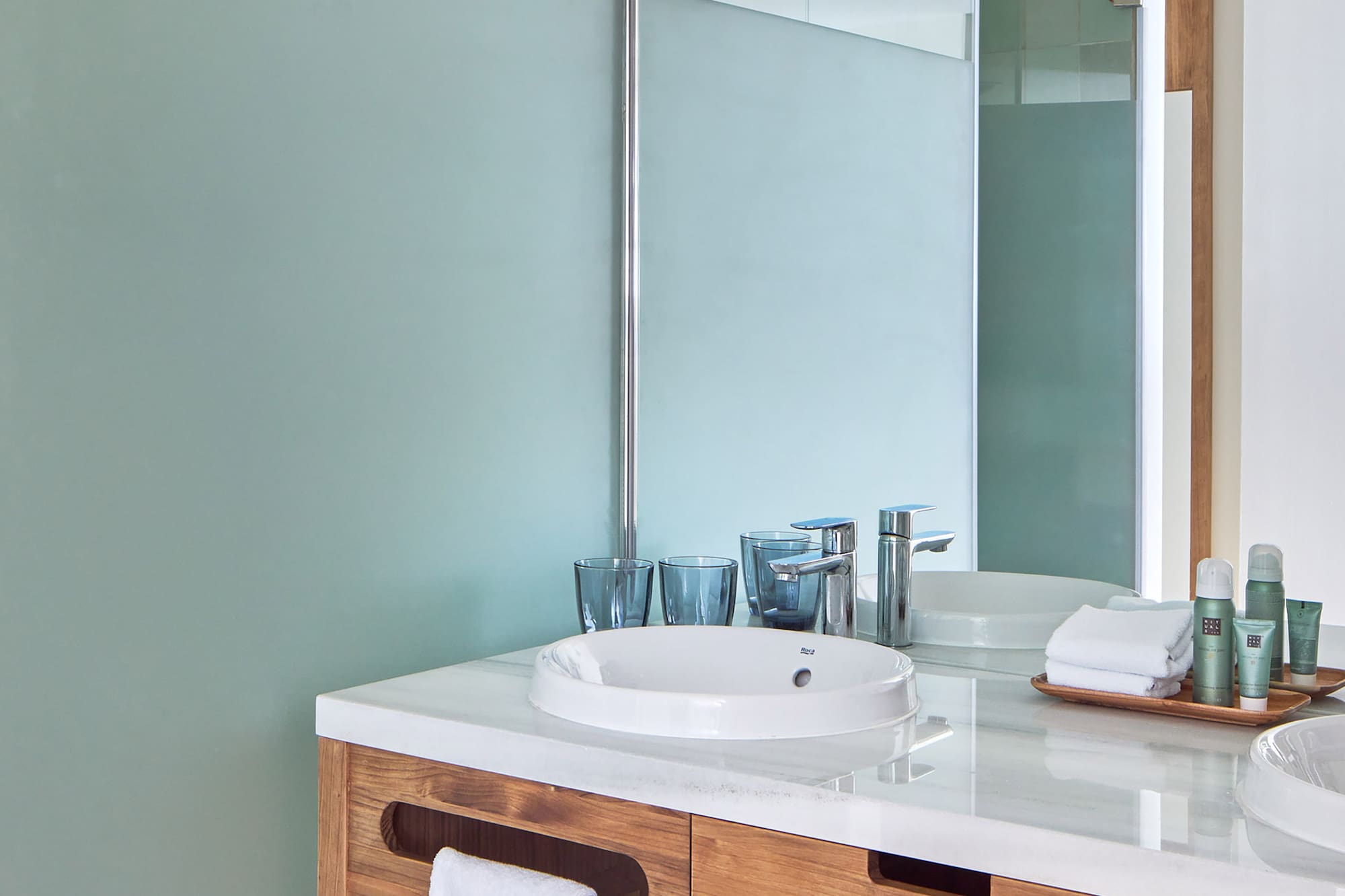 a bathroom with a shower and sink