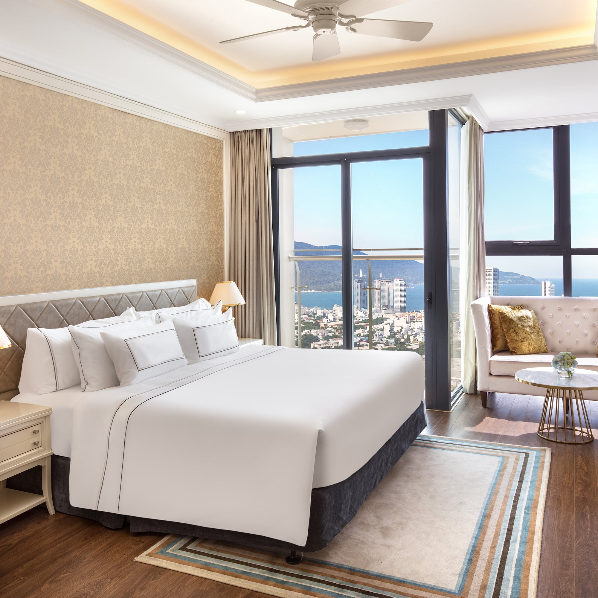 a bedroom with a large window and a large bed