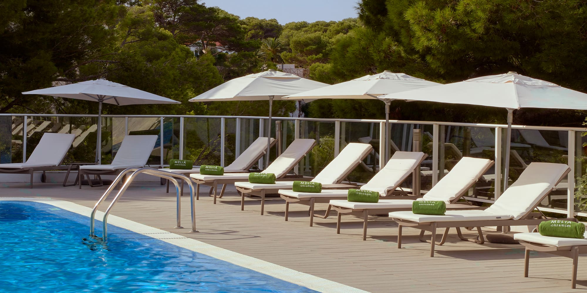 a pool with chairs and umbrellas