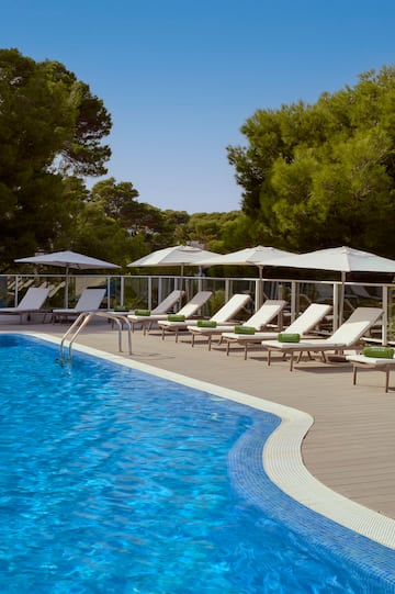 a pool with chairs and umbrellas