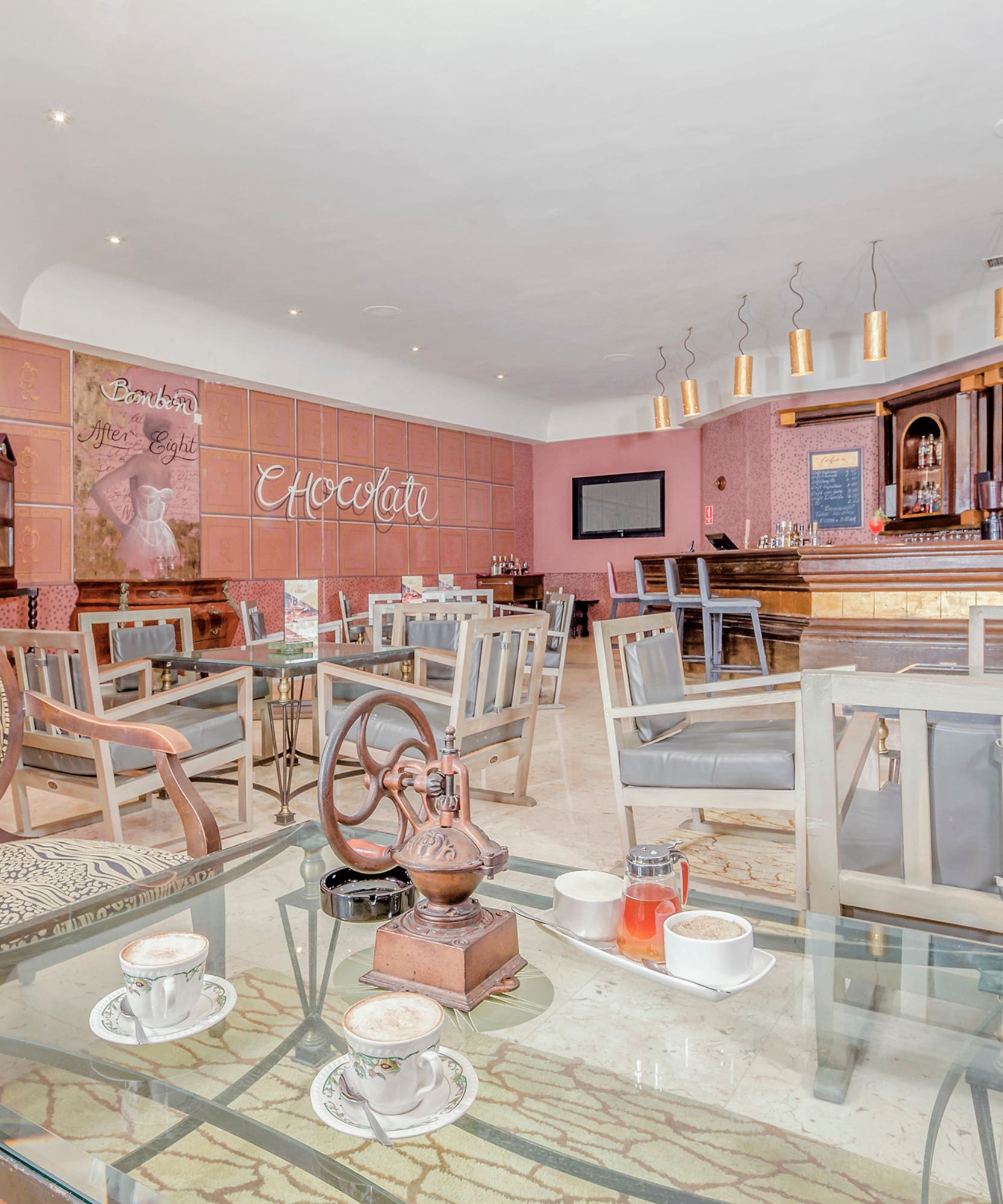 a room with a glass table and chairs