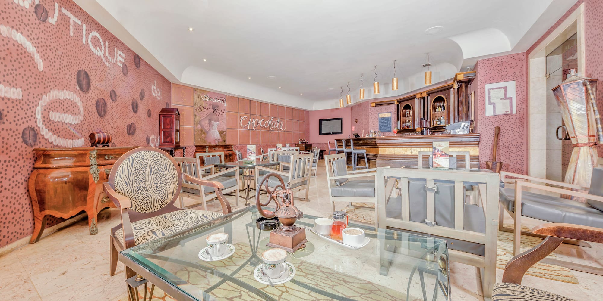 a room with a glass table and chairs