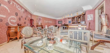 a room with a glass table and chairs