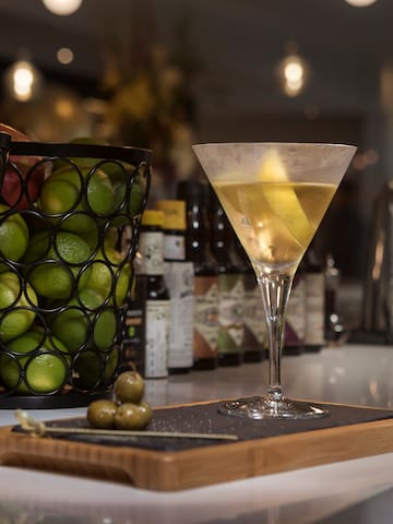 a glass of liquid next to a tray of fruit