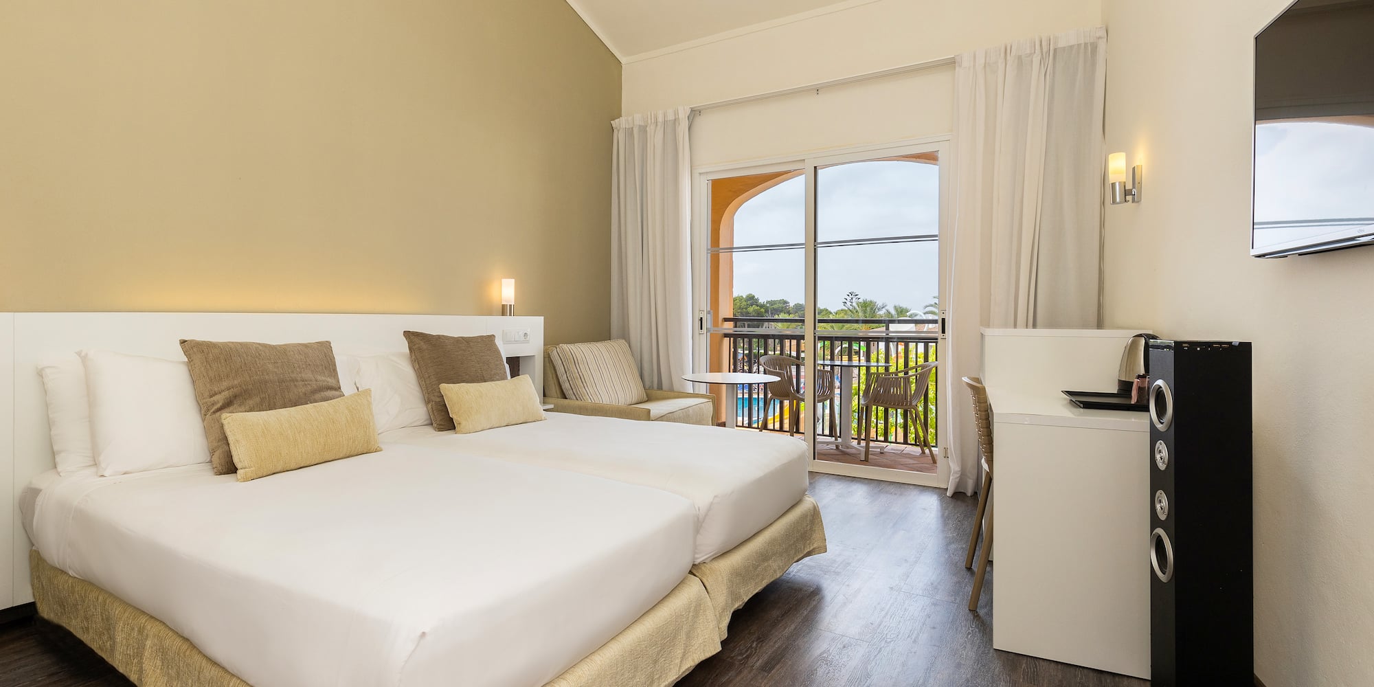 a room with a bed and a table and chairs