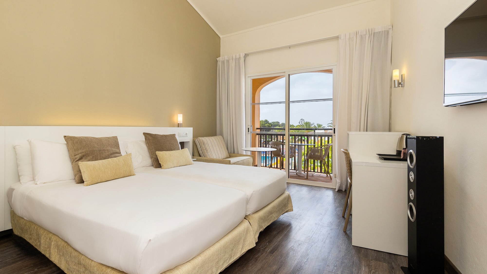 a room with a bed and a table and chairs