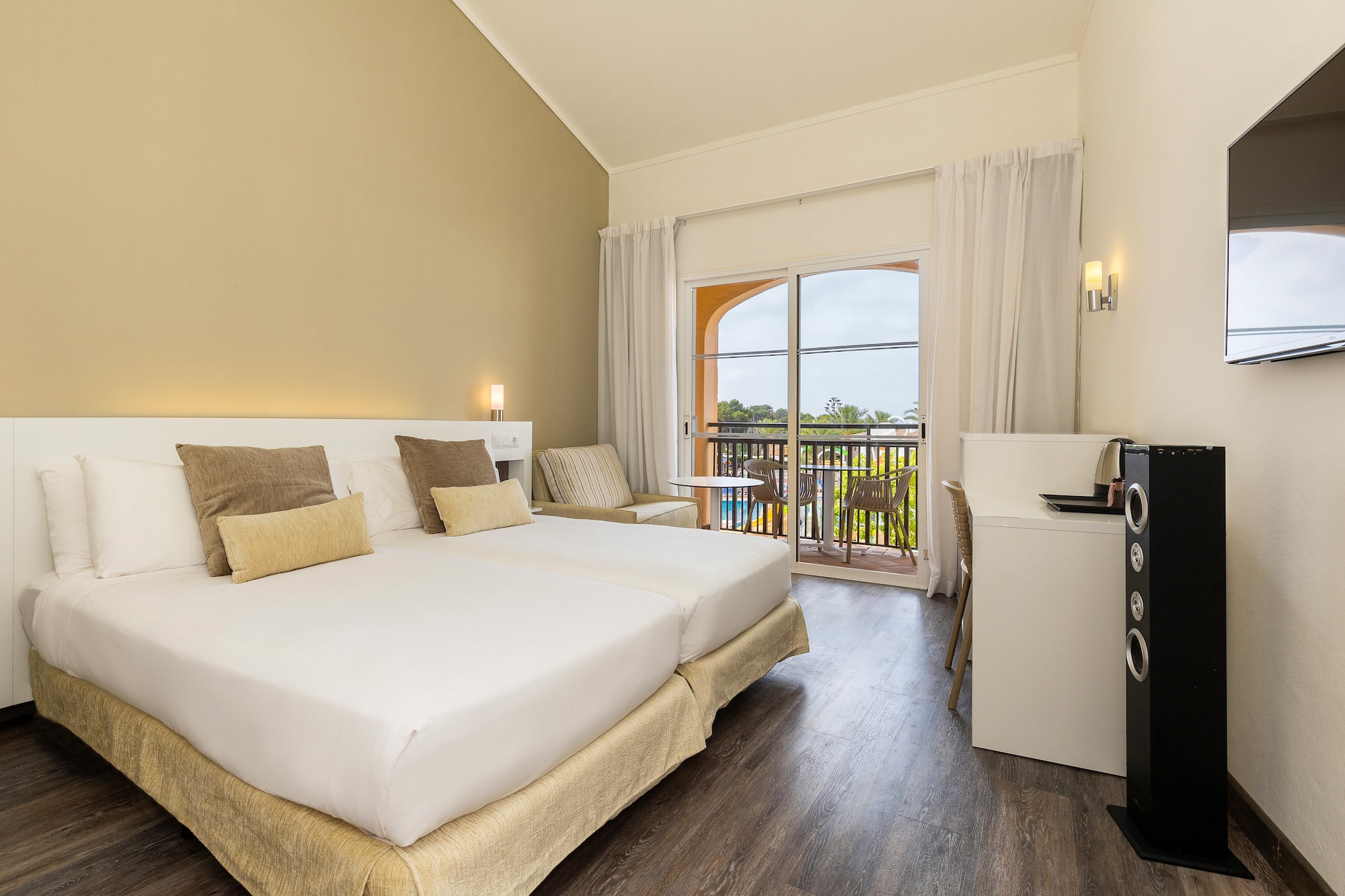 a room with a bed and a table and chairs