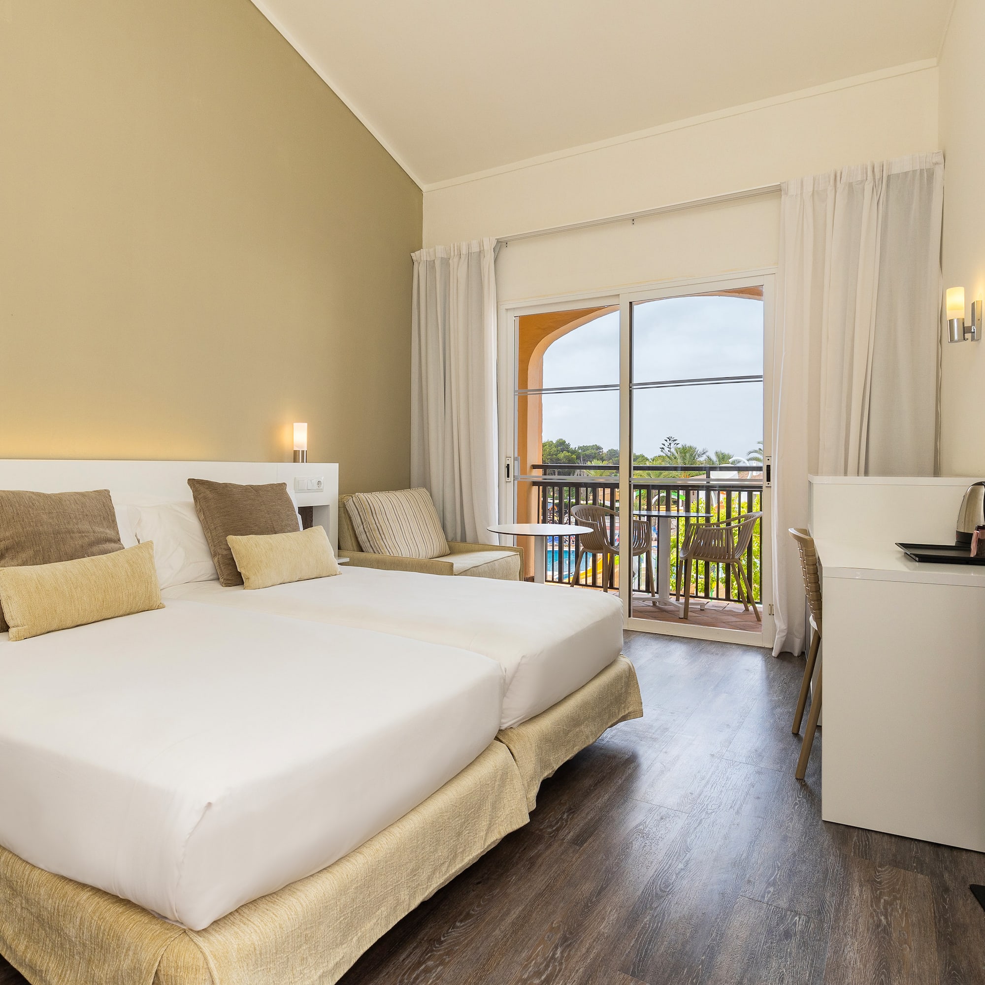 a room with a bed and a table and chairs