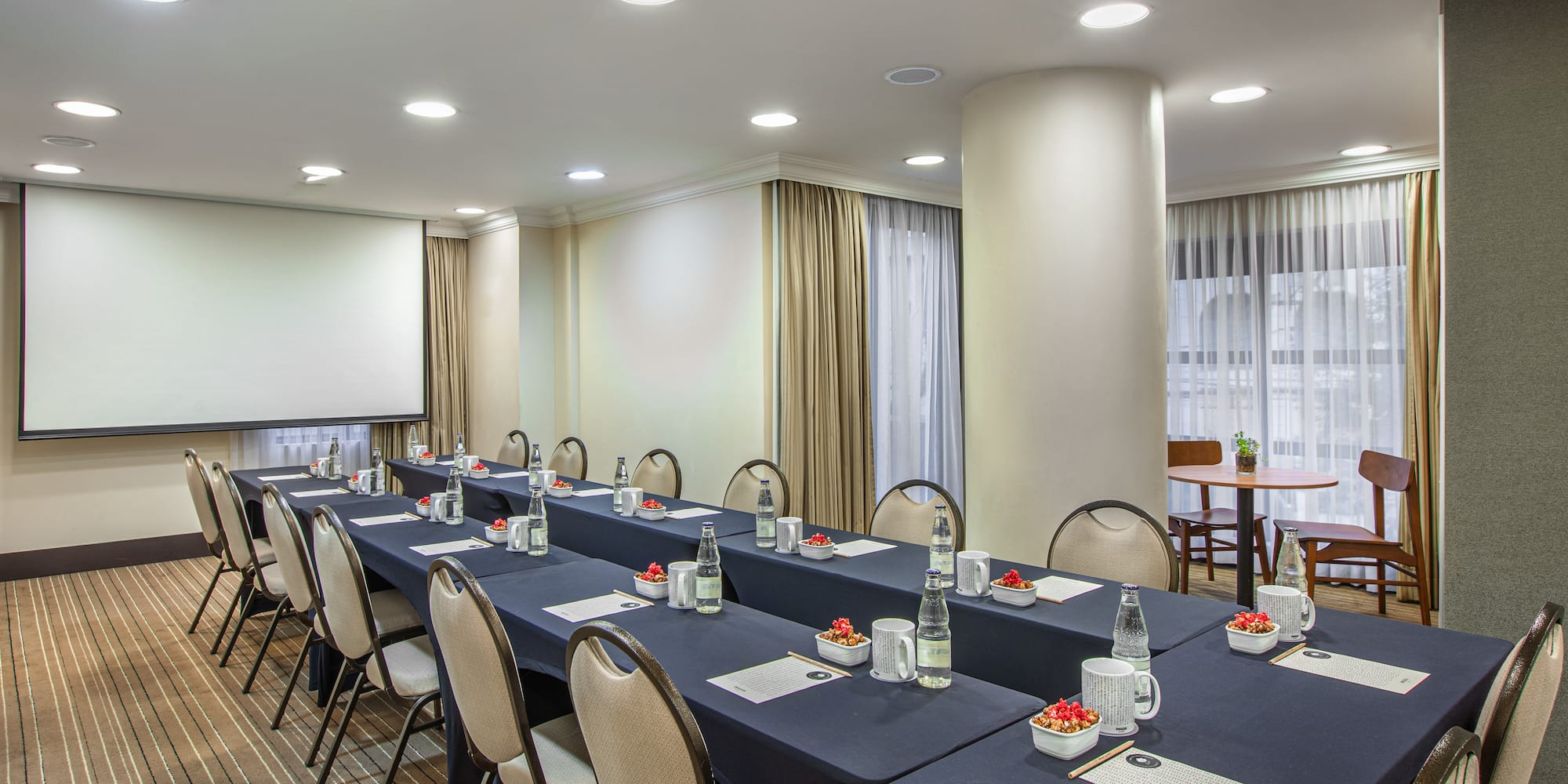 a room with long tables and chairs