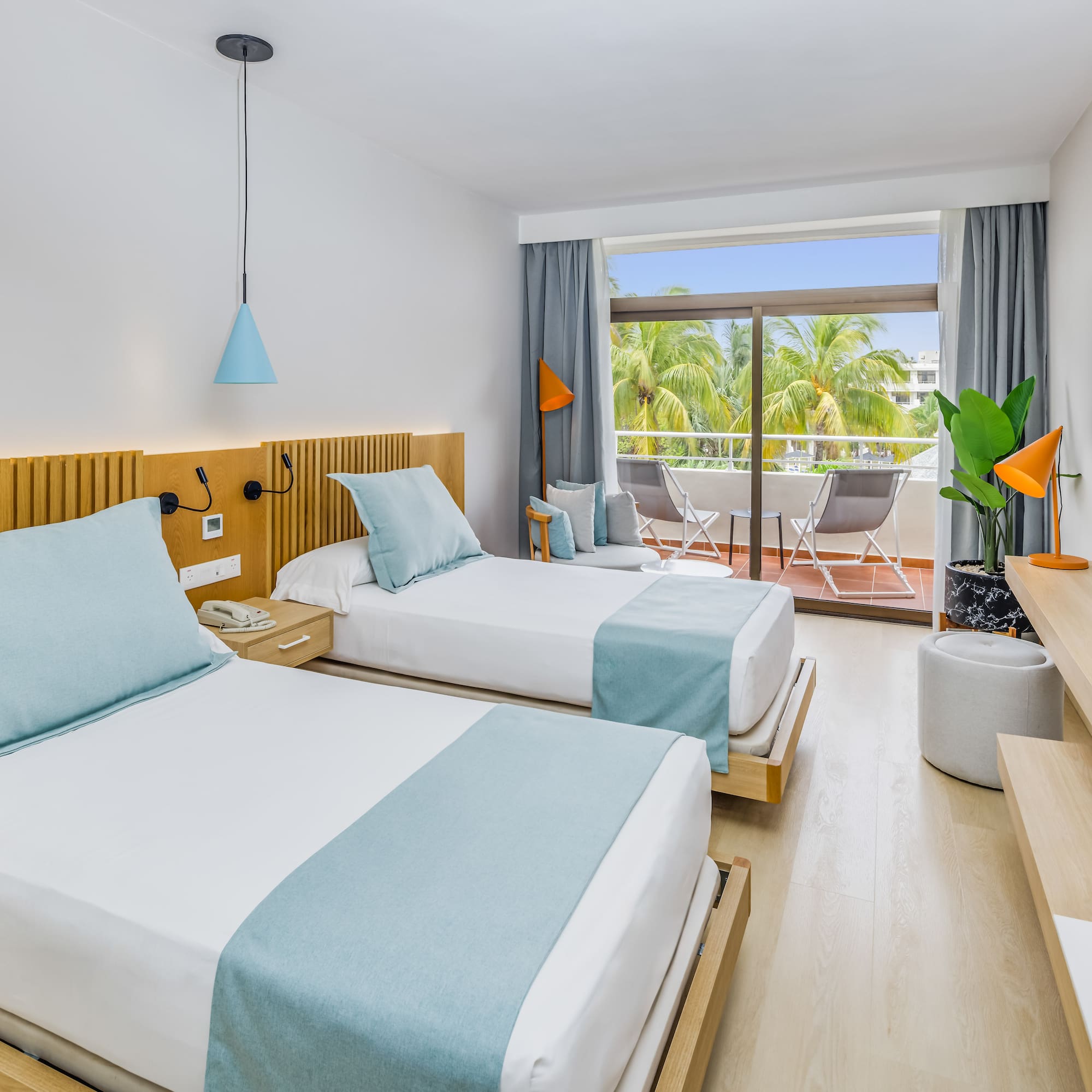 a room with two beds and a balcony