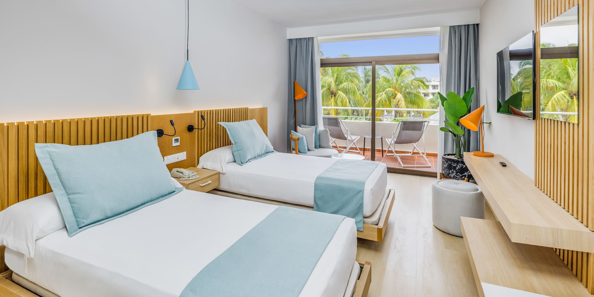 a room with two beds and a balcony