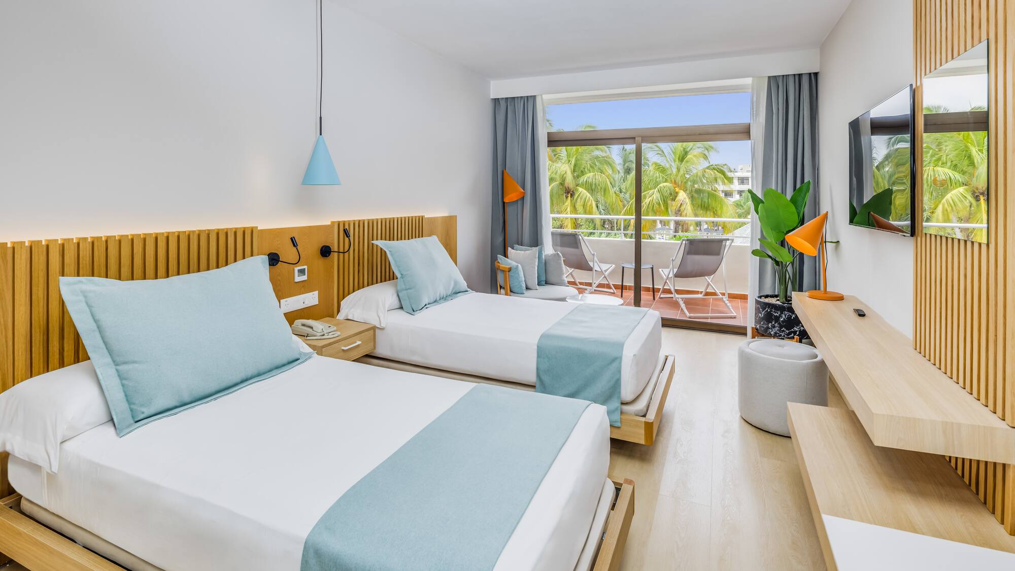 a room with two beds and a balcony