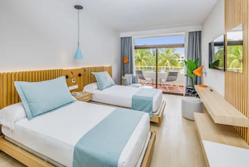 a room with two beds and a balcony