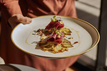 a person holding a plate of food
